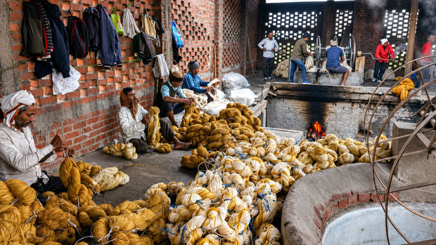 Natural wool, silk, and recycled sari silk materials used in handcrafted rug production