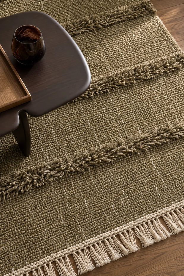 Skilled artisan crafting a hand tufted rug with precision and attention to detail